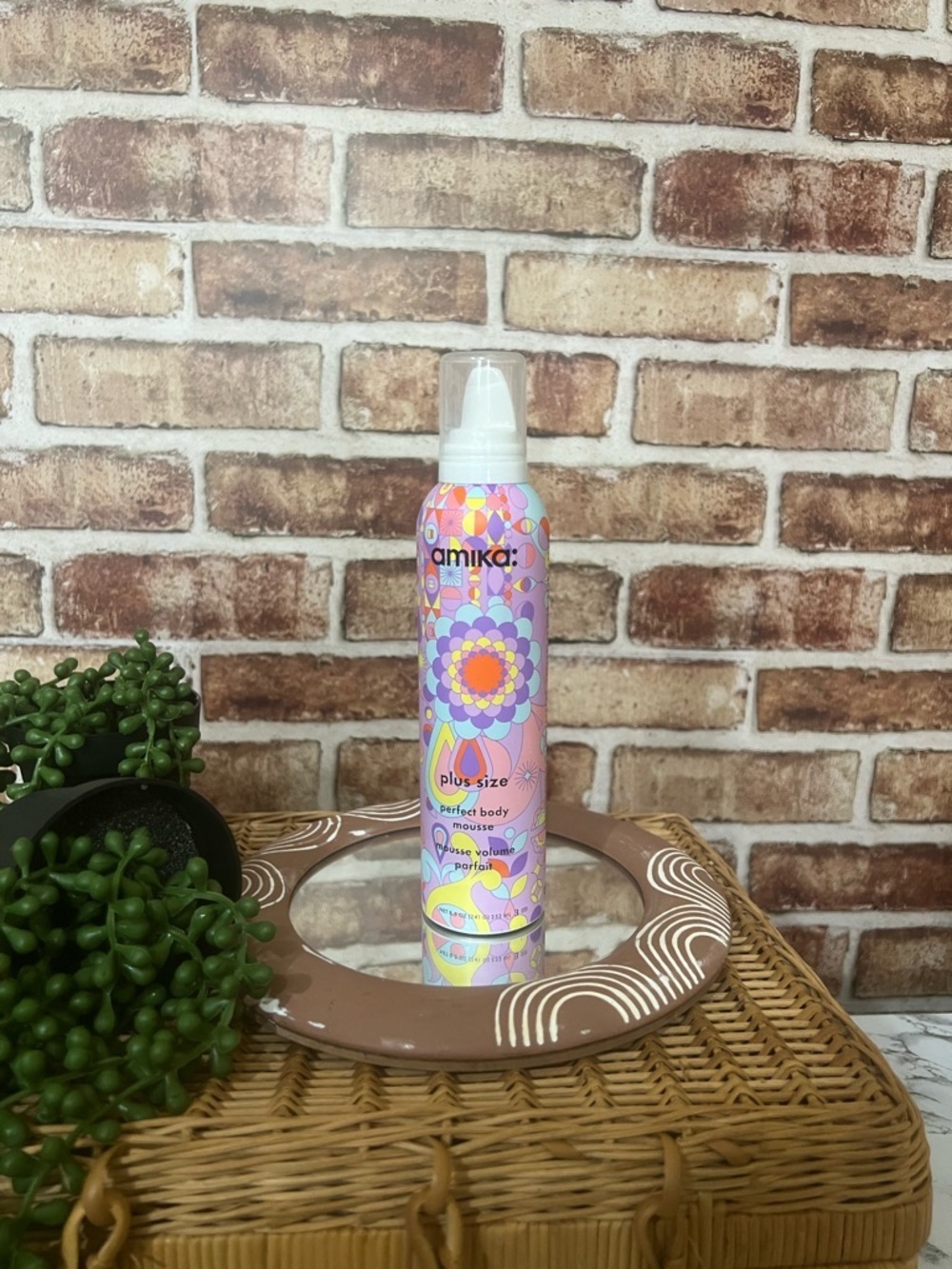 amika body mousse in pink, purple & yellow patterned bottle